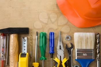 set of construction tools and instruments on wood background