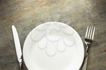 plate, knife and fork on table background