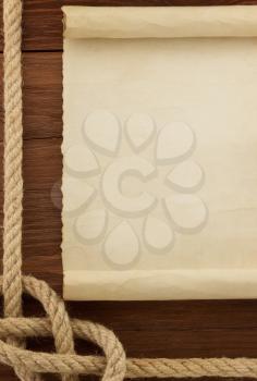 ropes and old vintage ancient paper at wood background