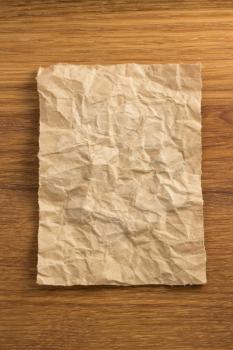 wrinkled paper  on wooden background