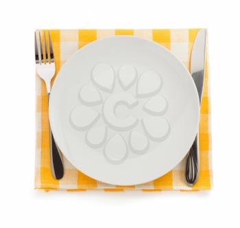 plate, knife and fork at napkin on white background
