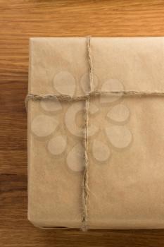 parcel wrapped packaged box on wooden background