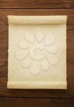 parchment scroll on wood background
