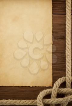 ropes and old vintage ancient paper at wood background