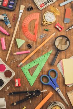school supplies and notebook on wooden background