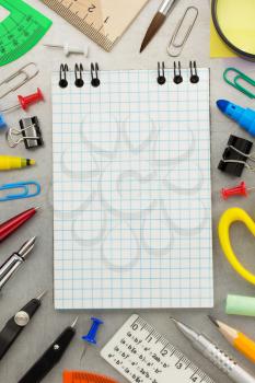 notebook and school accessories at old background texture