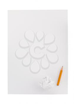 pencil and crumpled paper ball on white background