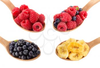 fruit and berry in spoon on white background