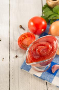 tomato sauce on wooden background