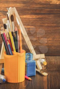 paint supplies on wooden background