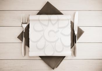 parchment and napkin on wooden background