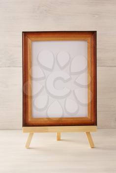 paint frame on wooden background