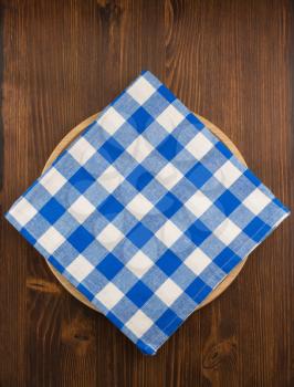 napkin cloth and cutting board on wooden background