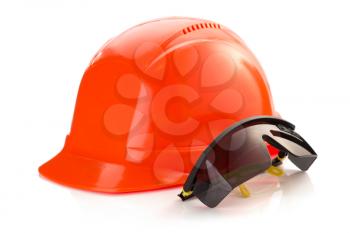 construction helmet and safety glasses on white background
