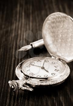 old pocket watch on wooden background