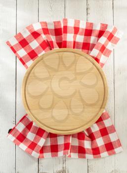 cloth napkin and cutting board on wooden background