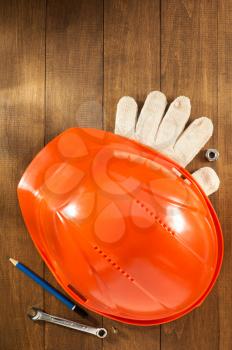 hardhat and  tools on wooden background