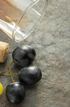 grapes and wine glass on table