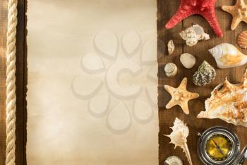 old paper and seashell on wooden background texture