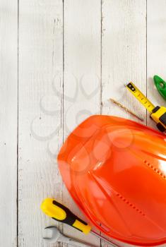 hardhat and tools on wooden background
