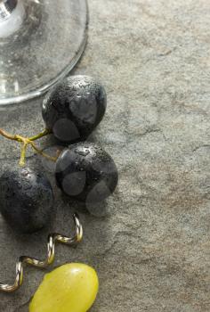 grapes and wine glass on table