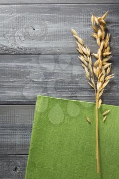ears of oat on wooden background