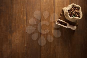 coffee beans in bag on wooden background