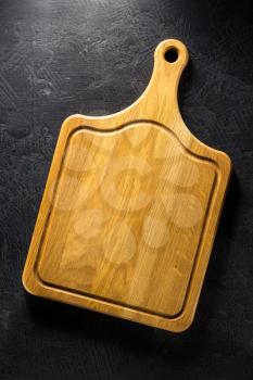 pizza cutting board at black background texture