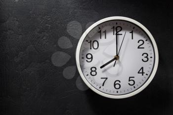 wall clock at black background texture