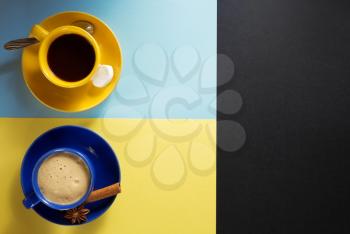 cup of coffee  and cacao at colorful paper background