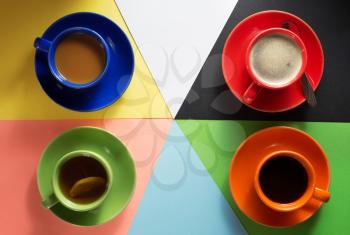 cup of coffee, tea and cacao at colorful paper background