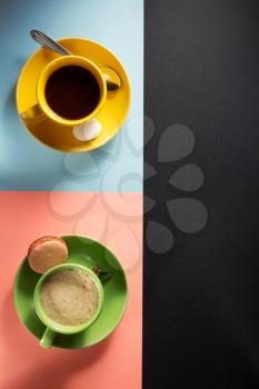 cup of coffee and cacao at colorful paper background