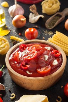 tomato sauce in bowl on black background texture