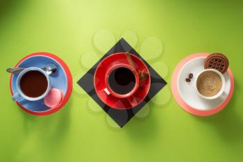 cup of coffee, tea and cacao at colorful background
