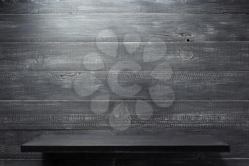 wooden shelf at black  background texture