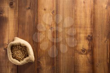 wheat grains on wooden plank background