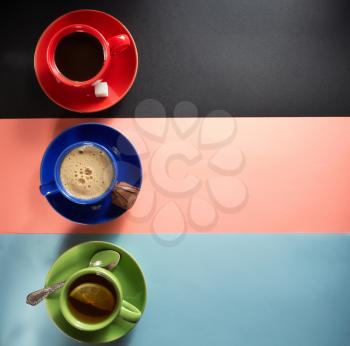 cup of coffee and tea at colorful paper background