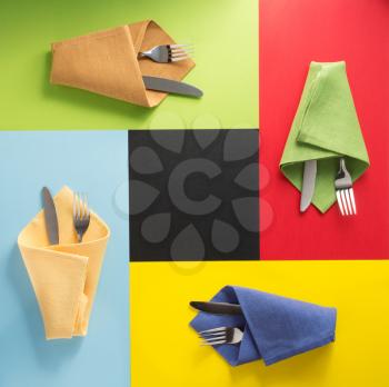 knife and fork at napkin at colorful background