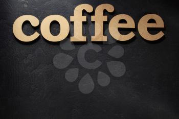 coffee wooden letters on black background