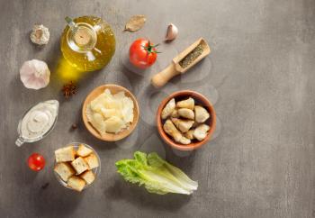 caesar salad ingredients at stone  table background
