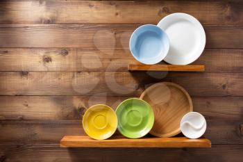 plate at kitchen wooden shelf at wall background