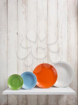 plate at kitchen shelf on white wooden background