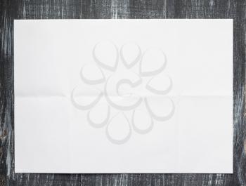 empty white wrinkled paper at wooden background