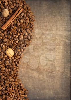 coffee beans and spices on wooden background, top view
