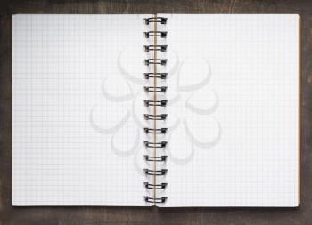 open notebook or book with empty pages at wooden  background, top view