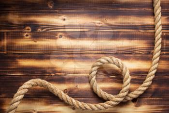 ship rope at wooden background, plank board texture