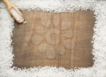 sea salt spice on wooden table background, top view