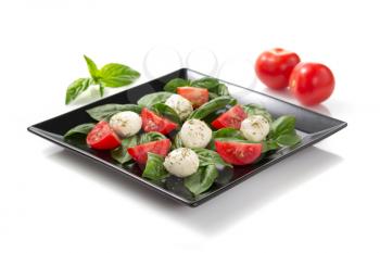 caprese salad in plate isolated on white background