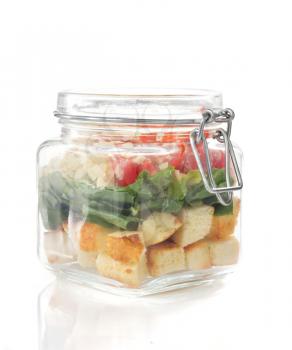 caesar salad in glass jar isolated on white background