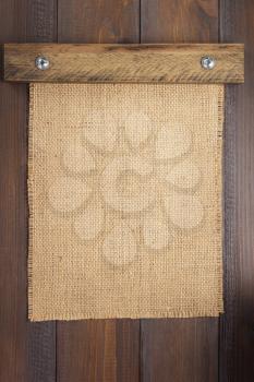 burlap hessian sacking texture on wooden background